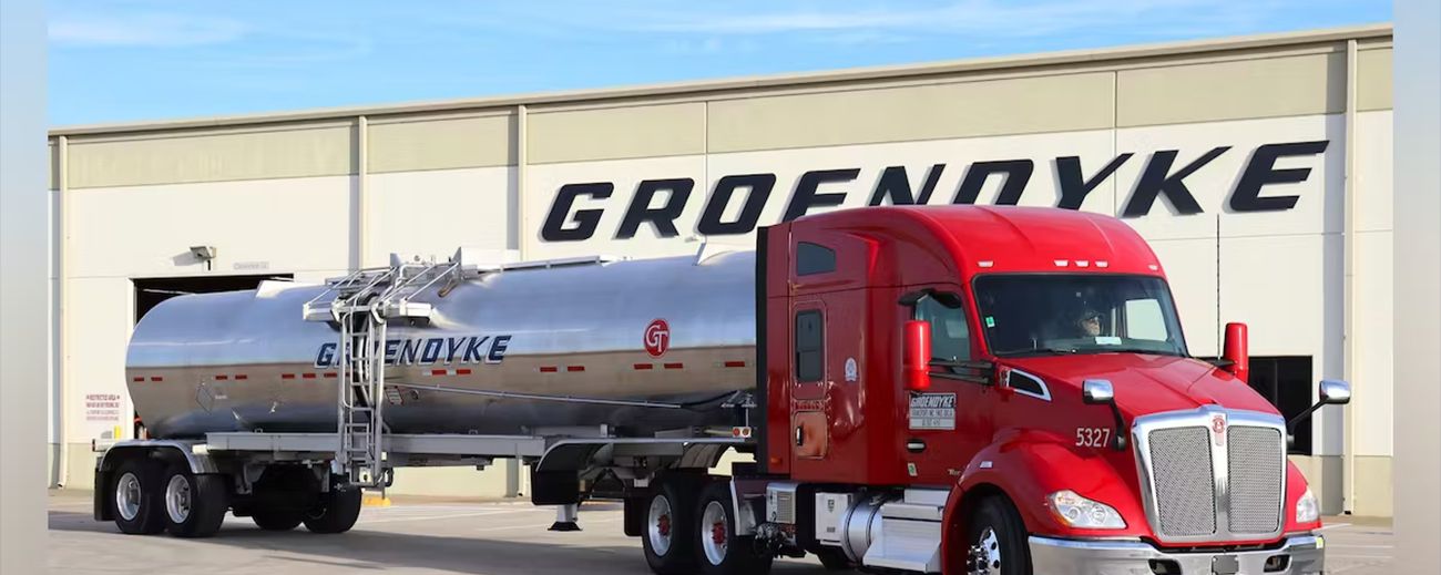 Photo of a building with Groendyke sign on it and truck in the foreground.